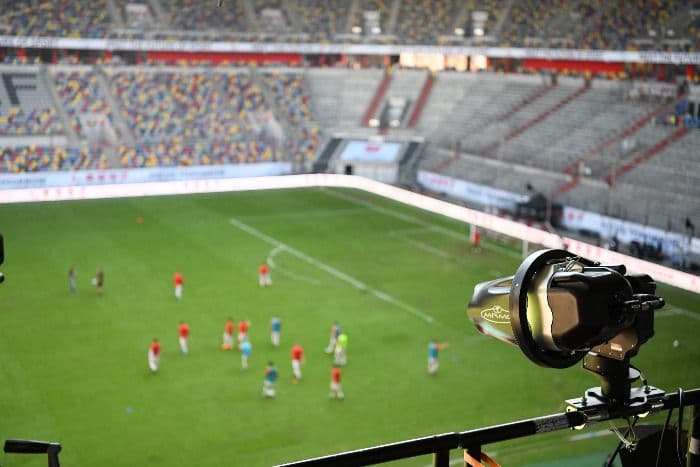 A microphone mounted to a railing at a soccer game