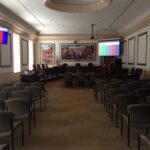 Annapolis City Council chambers with digital video displays