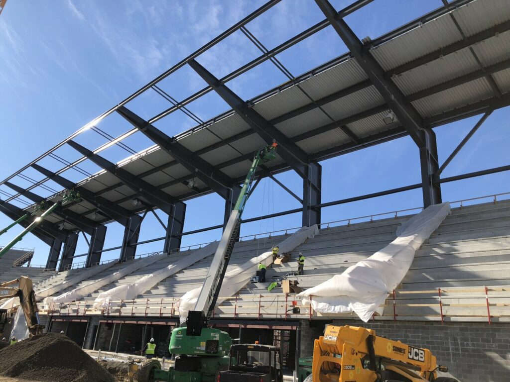 Josh Marrits of WPS installing speaker clusters at Audi Field