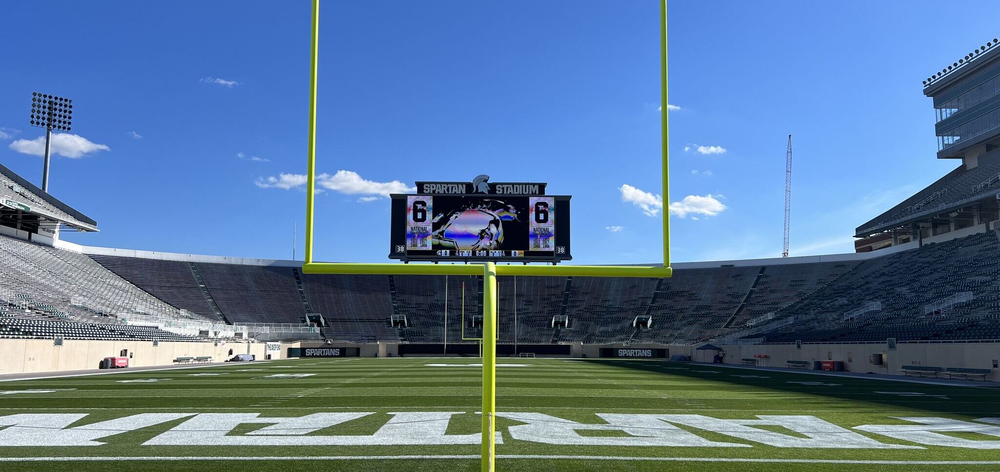 Wide view of Spartan Stadium's end zone, goal post, and scoreboard