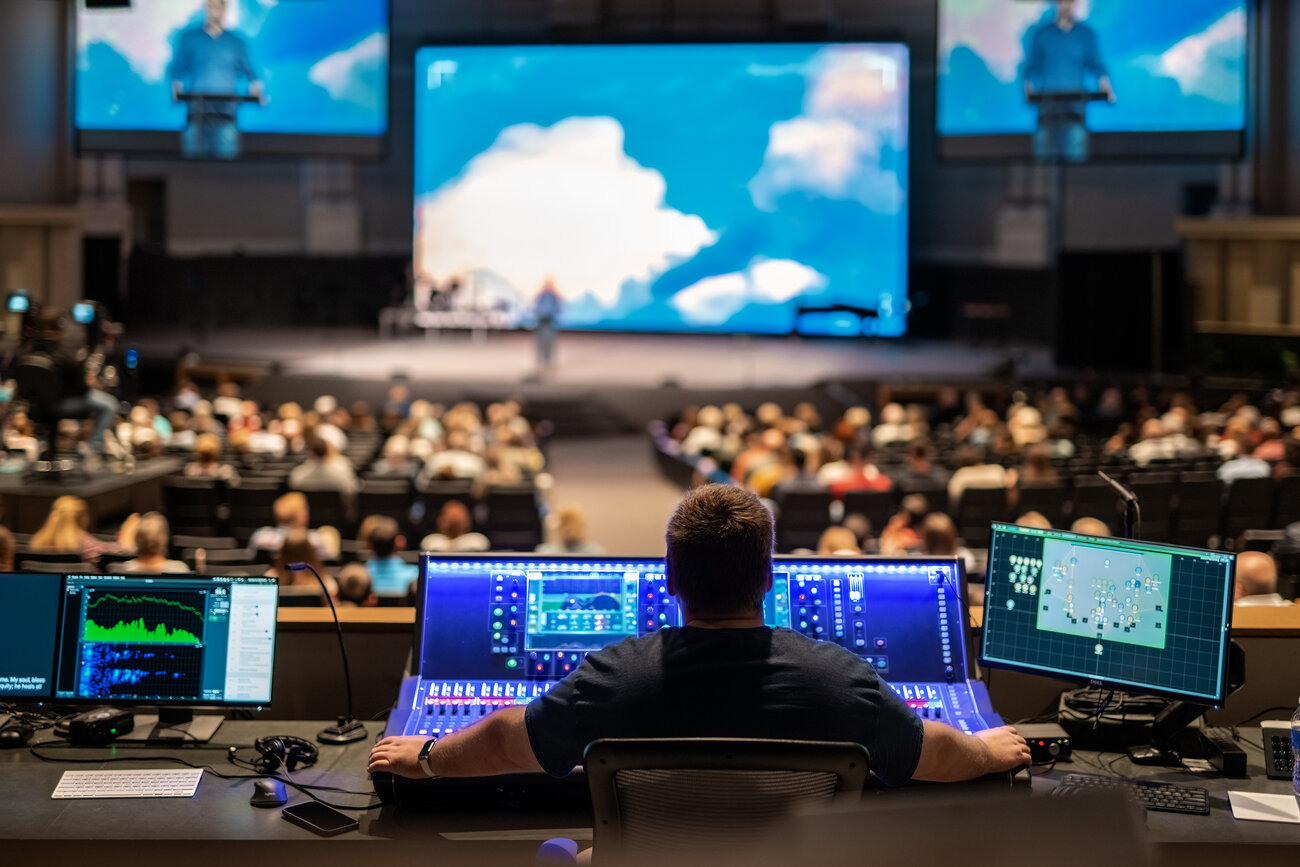 Audio engineer operating Allen&Heath console during sermon at Calvary Church