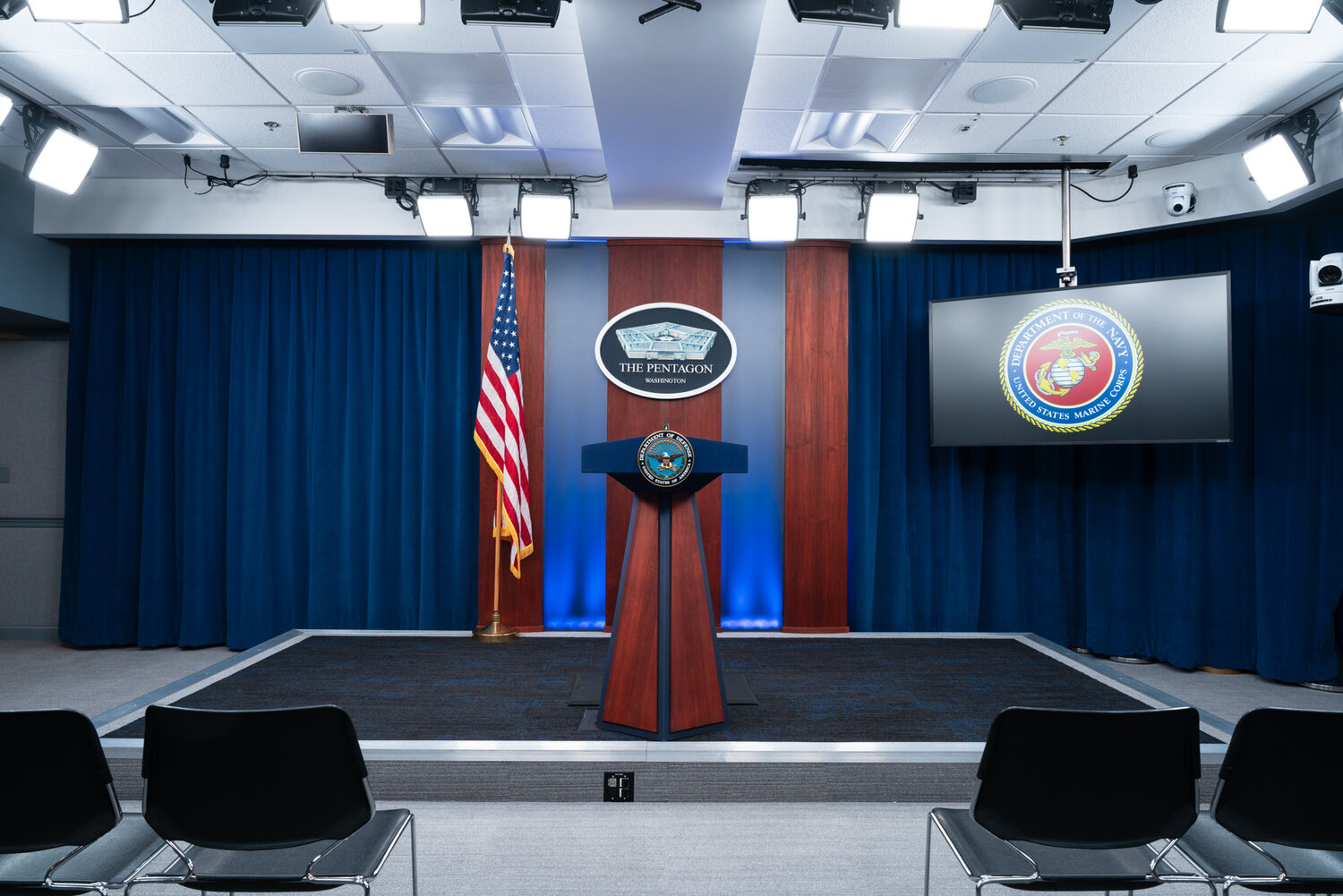 Direct view of the podium and stage of the Pentagon Briefing Room.